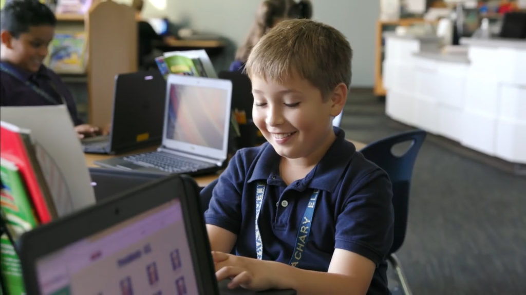 Smiling Student at Computer